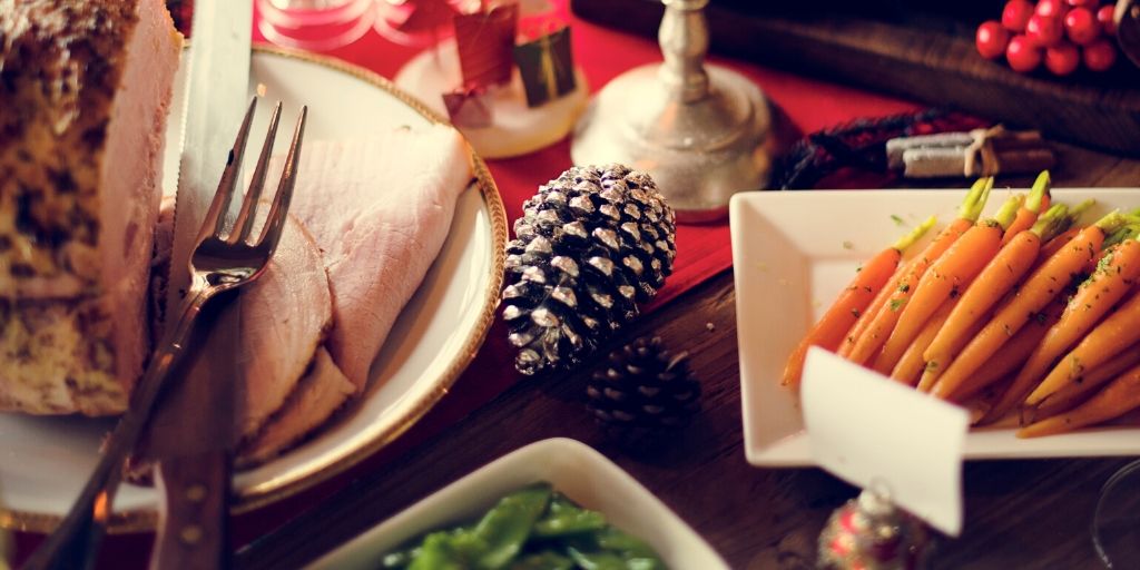 holiday dinner table with ham and carrots